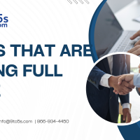 Professional reviewing listings for jobs that are hiring full time in the United States on a laptop in a modern office setting.