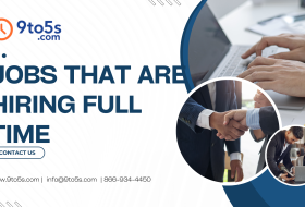 Professional reviewing listings for jobs that are hiring full time in the United States on a laptop in a modern office setting.